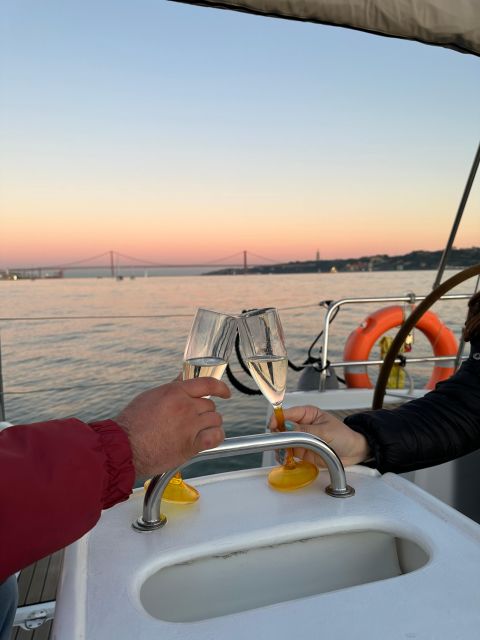 Lisbon: Romantic Cruise with Wine & Portuguese Tapas - Mid-cruise Lisbon: bridges, Time Out Market views, and the riverside in between
